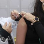 mulher é vacinada contra covid-19