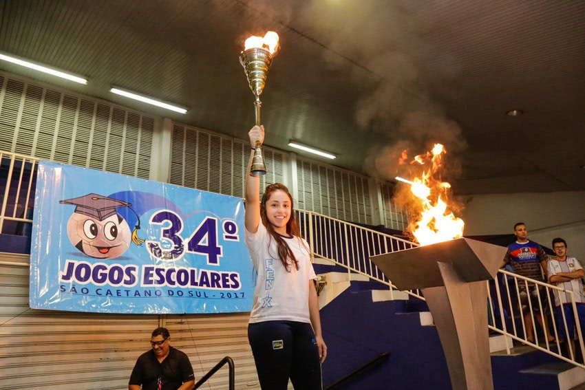 tocha dos jogos escolares é segurada por aluna